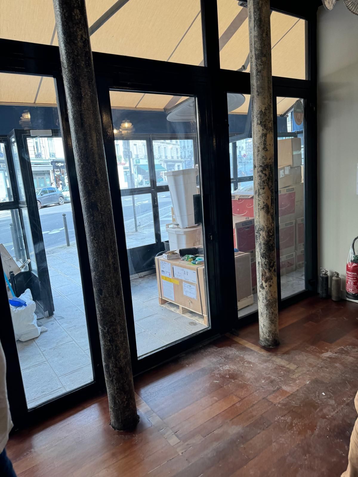A room with a lot of windows and a wooden floor