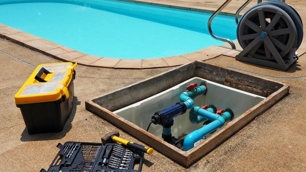 A Swimming Pool Is Being Repaired with Tools and A Toolbox — Beaches Pool Supplies in Kewarra Beach, QLD