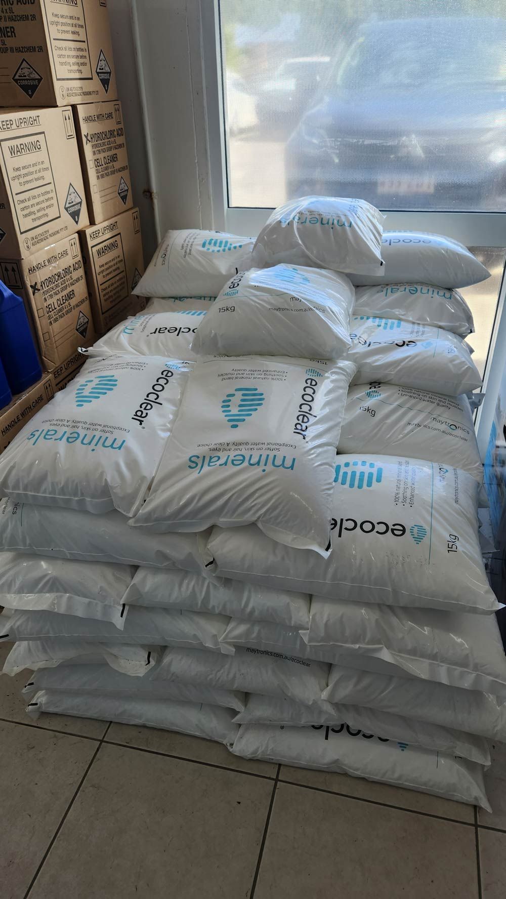 A pile of white bags stacked on top of each other in a room — Pool Shop in Kewarra Beach QLD