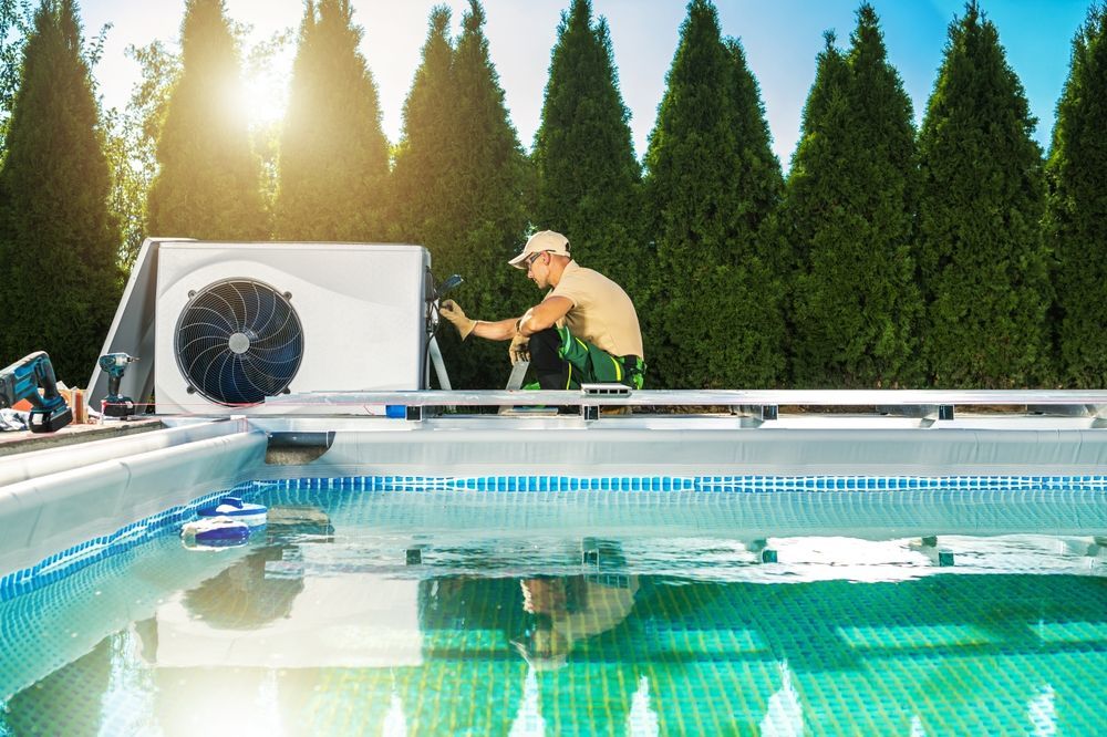 Man Installing A Pool Heat Pump For A Pool — Beaches Pool Supplies in Kewarra Beach, QLD
