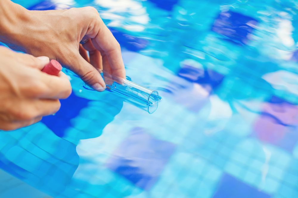 Taking Water Sample To A Flask For Testing — Beaches Pool Supplies in Kewarra Beach, QLD