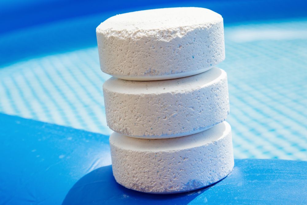 Chlorine Pellets On The Edge Of Pool — Beaches Pool Supplies in Kewarra Beach, QLD