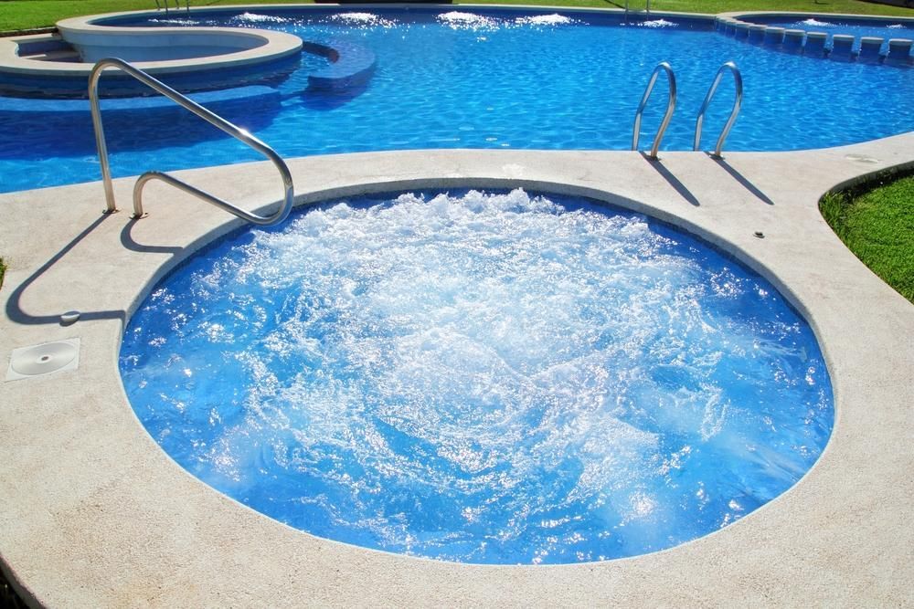 A Swimming Pool with A Jacuzzi in The Middle of It — Beaches Pool Supplies in Kewarra Beach, QLD
