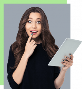 A woman is holding a tablet in her hand and smiling.