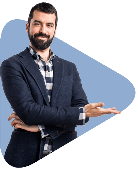A man in a suit and plaid shirt is standing with his arms crossed