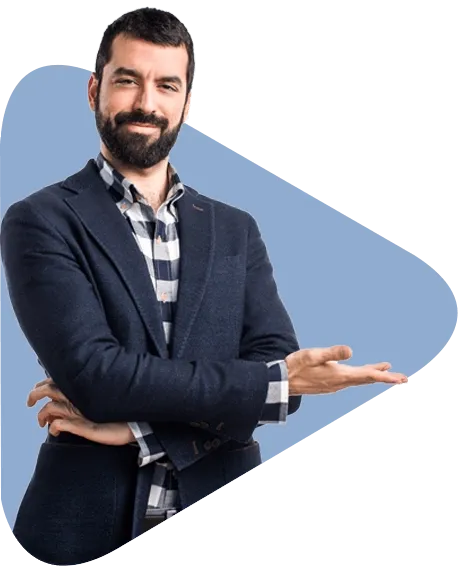 A man in a suit and plaid shirt is standing with his arms crossed