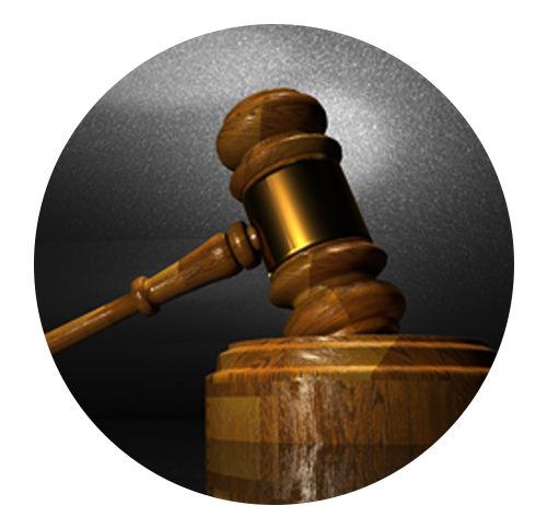 A wooden judge 's gavel is sitting on a wooden block
