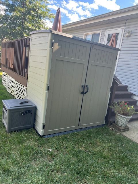Outdoor shed and deck project with new paint and fencing added for improved privacy.