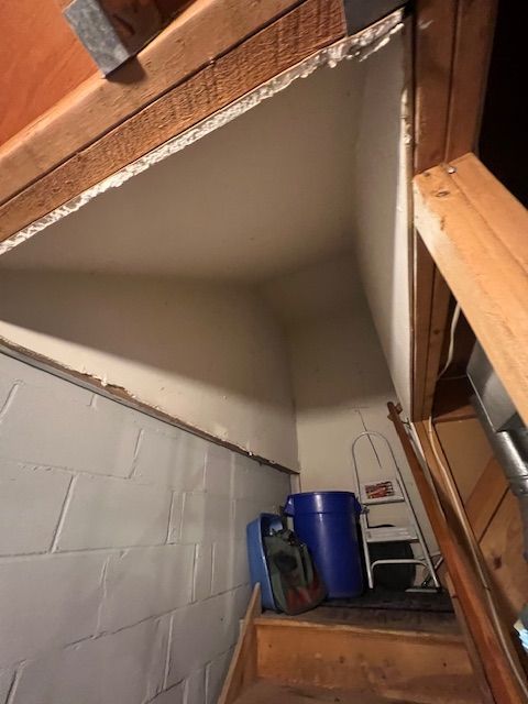 Home renovation in progress showing framing work and drywall removal inside an unfinished interior.
