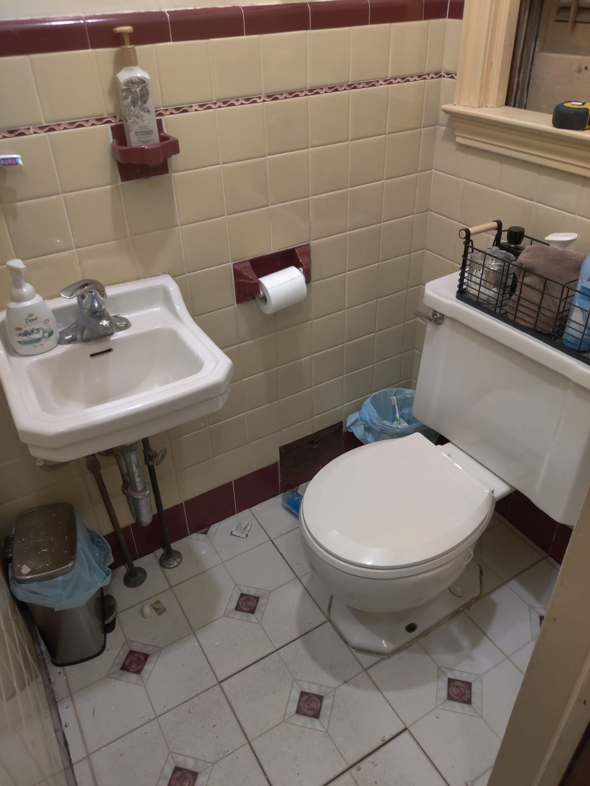 Bathroom upgrade with tile repair, updated fixtures and refreshed wall detailing.