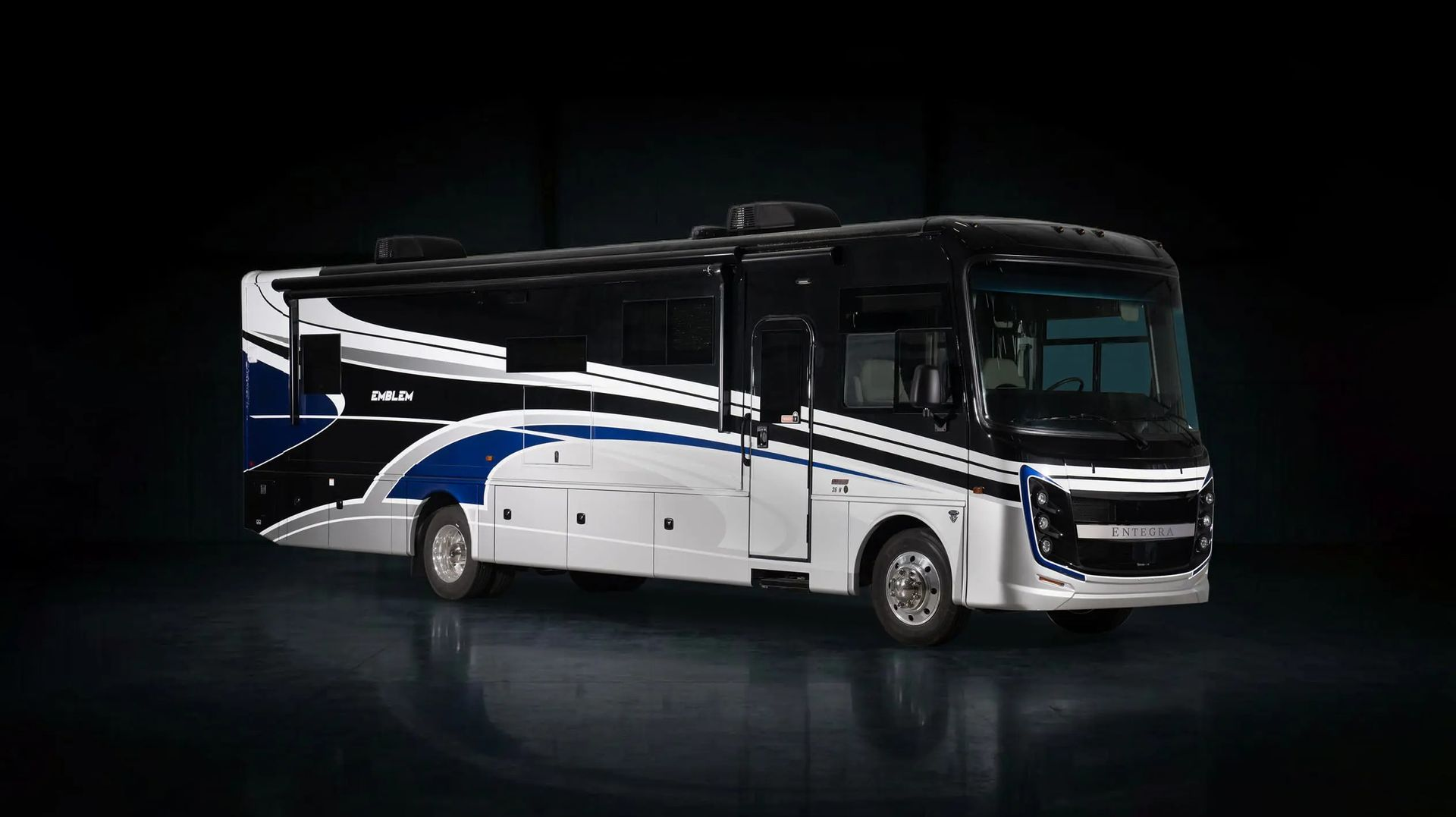 White and blue luxury tour bus on a dark background, side view