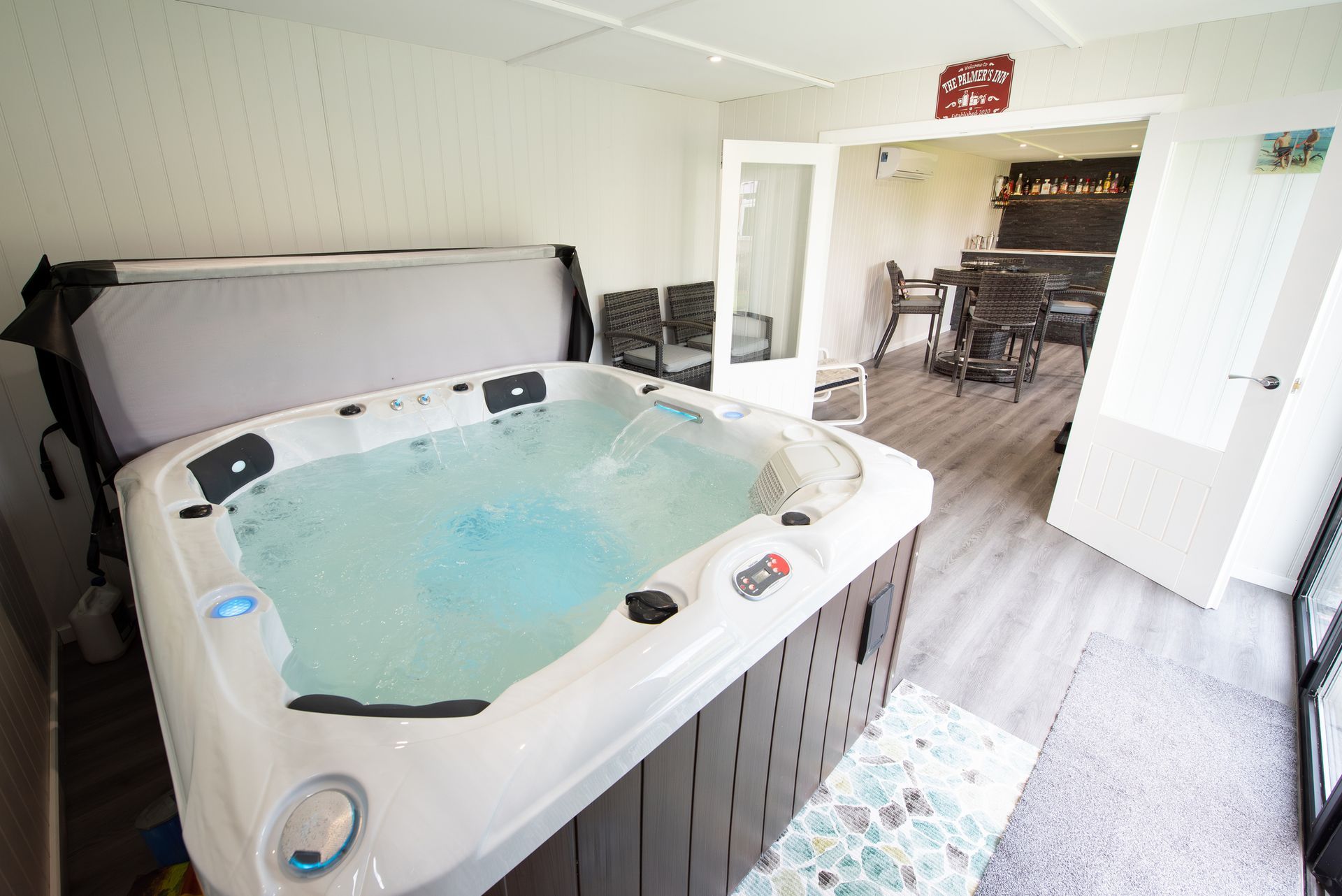 A hot tub is sitting in the middle of a living room. A hot tub is sitting in the middle of a living room.