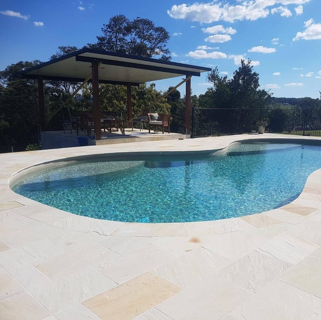 A Large Swimming Pool Surrounded By Trees On A Sunny Day — Ballina Pool Shop In Ballina, NSW