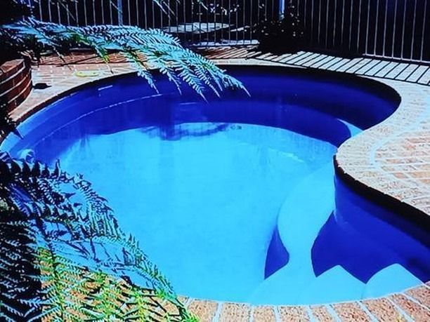 A Blue Swimming Pool With Stairs Leading To It — Ballina Pool Shop In Yamba, NSW