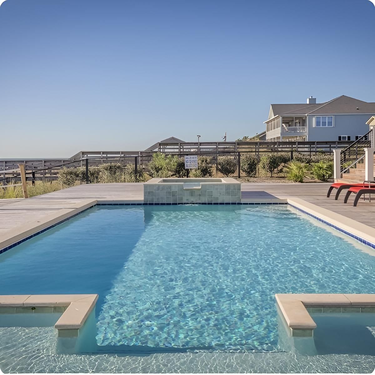 A Large Swimming Pool With A House In The Background — Ballina Pool Shop In Ballina, NSW