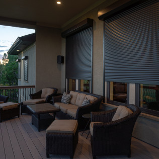 A patio with a couch chairs and a table