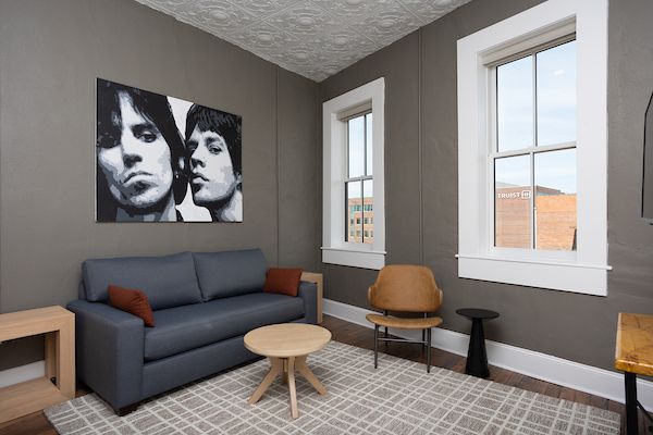 Interior photo with blue sofa. Art on the wall.