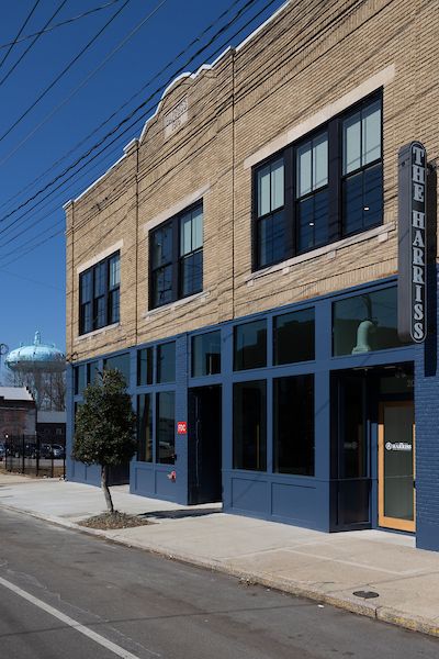 Exterior of a building with  blue paint and yellow brick.