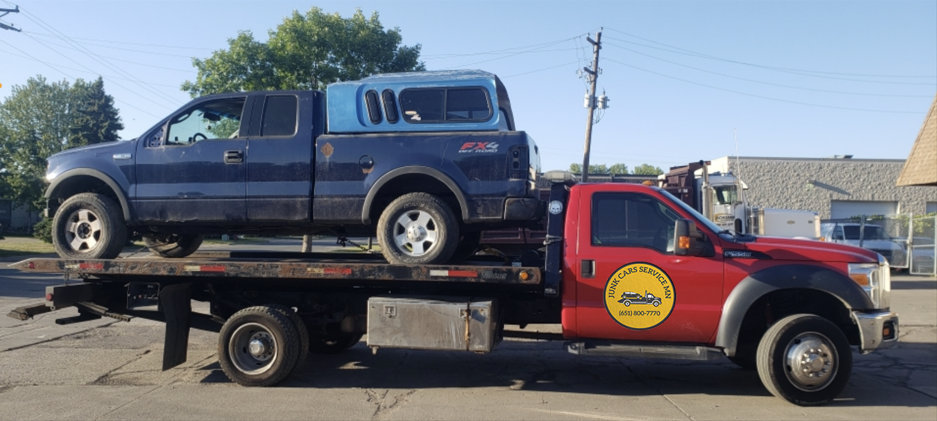 junk car on the red tow truck