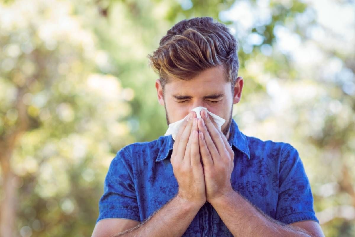 Someone blowing their nose to alleviate springtime allergies in Central Kentucky (KY) near Harrodsburg, Kentucky (KY)