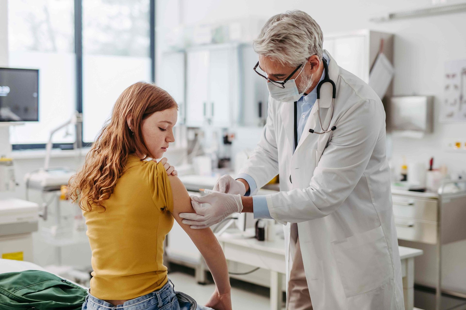An adolescent receiving a vaccine from a medical professional near Harrodsburg, Kentucky