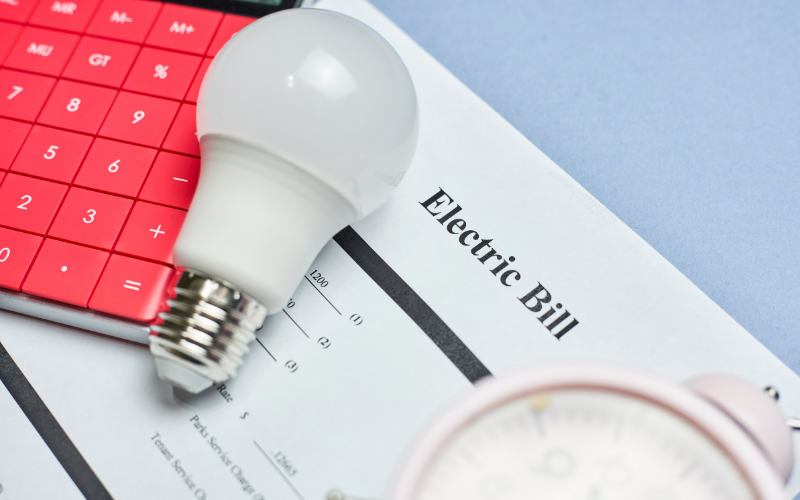 A light bulb is sitting on top of an electric bill