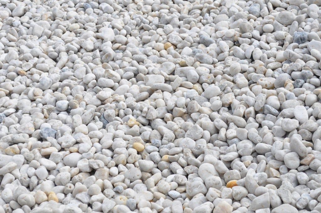 White gravel stones covering a surface.