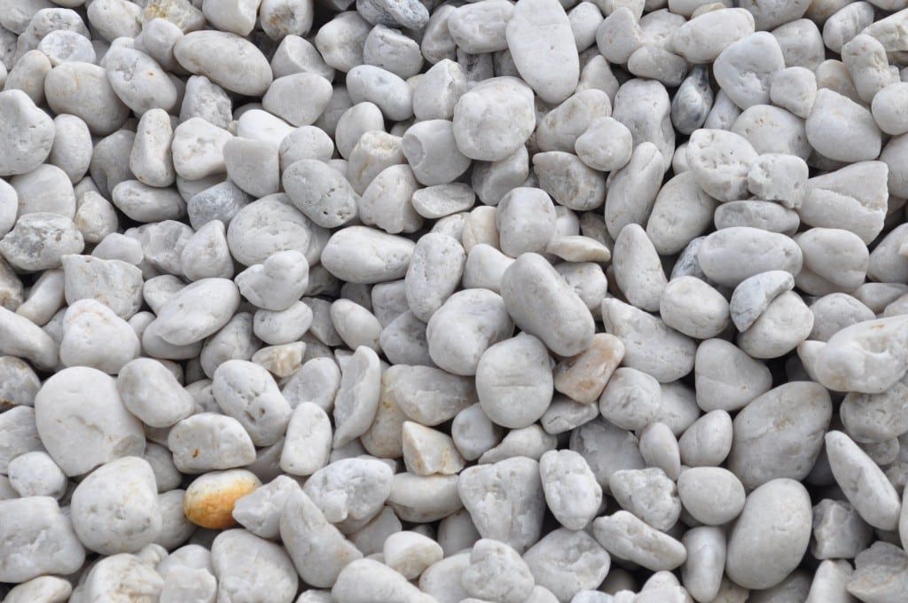 Close-up view of a pile of smooth, white river rocks.
