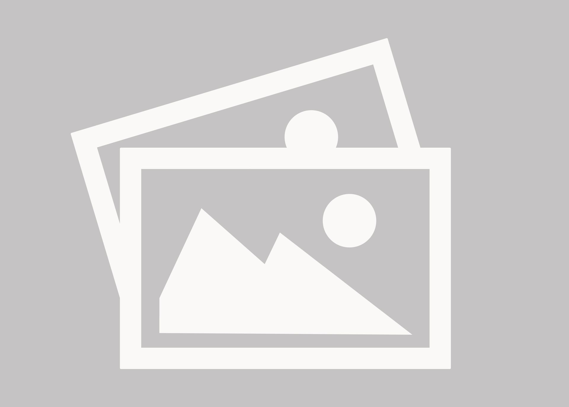 Two overlaid rectangular frames, one depicting mountains and the sun, the other a white circle.