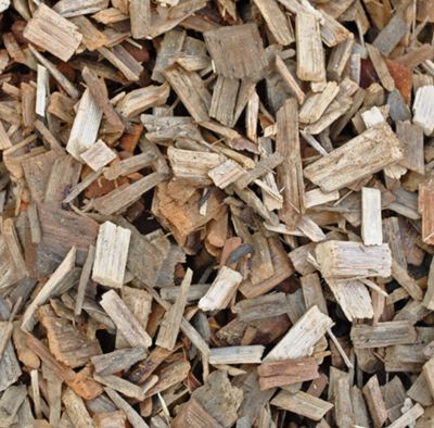 Wood chips, various shades of brown and tan, scattered and piled together.