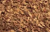 Brown wood chips, various shapes and sizes, covering the ground.
