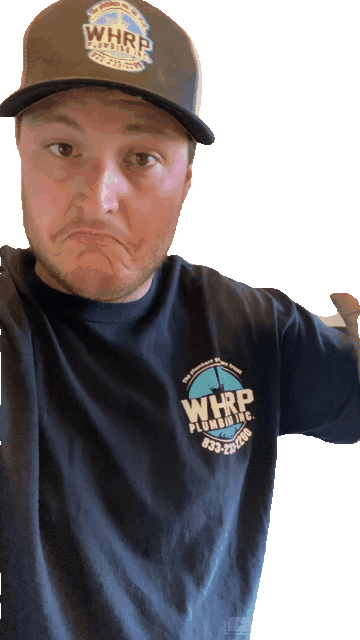 A man wearing a hat and a black shirt is making a funny face.