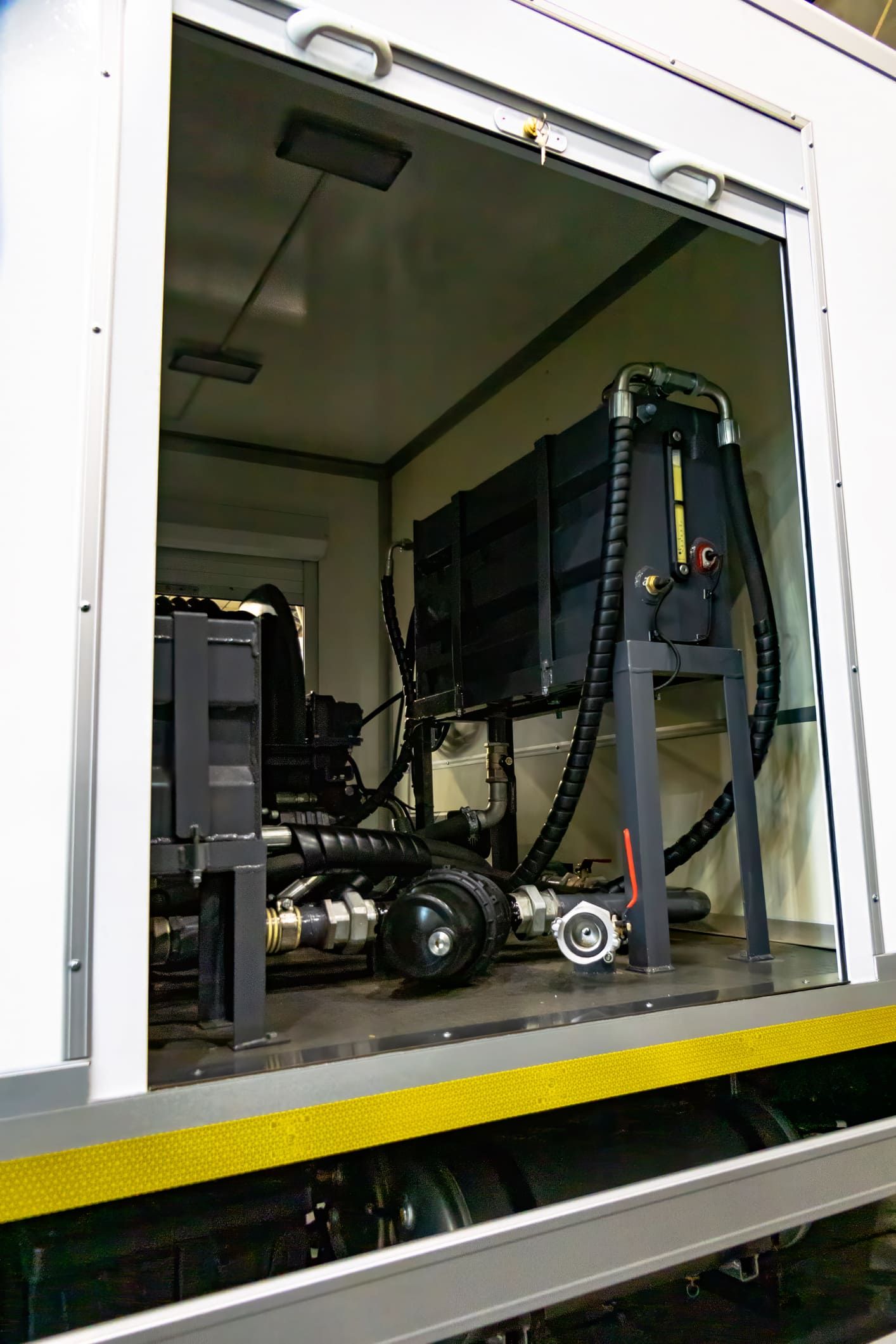 A truck with the door open and a machine inside of it.