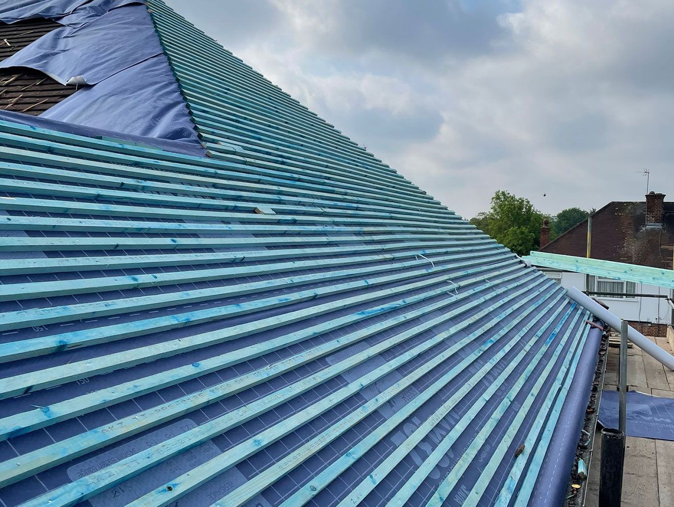 A blue roof is being built on top of a building.