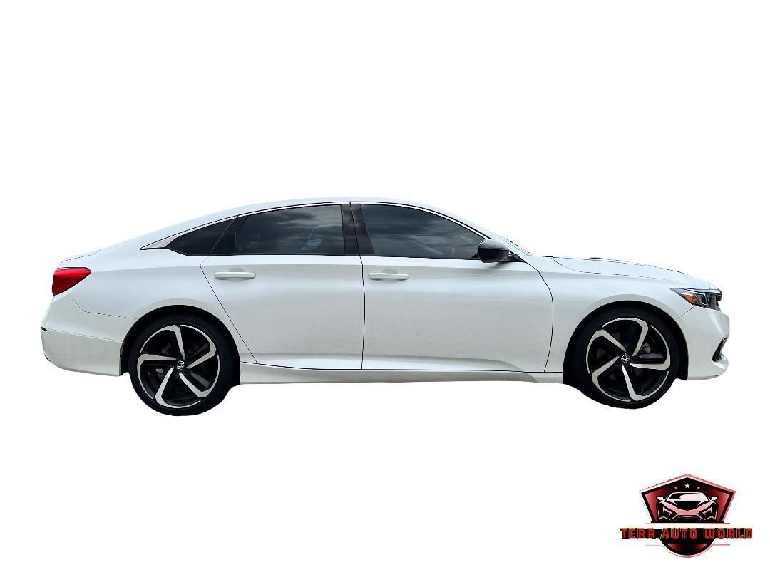 A side-profile view of a white sedan with dark tinted windows and black multi-spoke wheels on a plain white background.