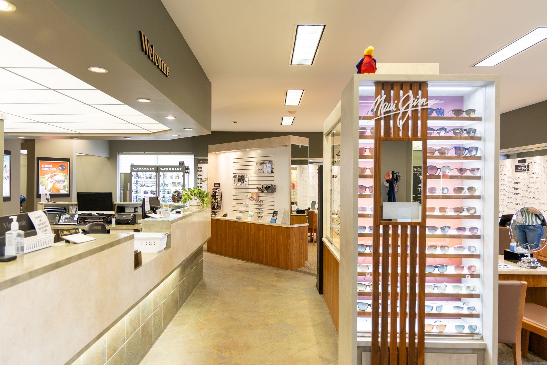 Interior of an eyeglasses store with display racks, counters, and bright overhead lighting