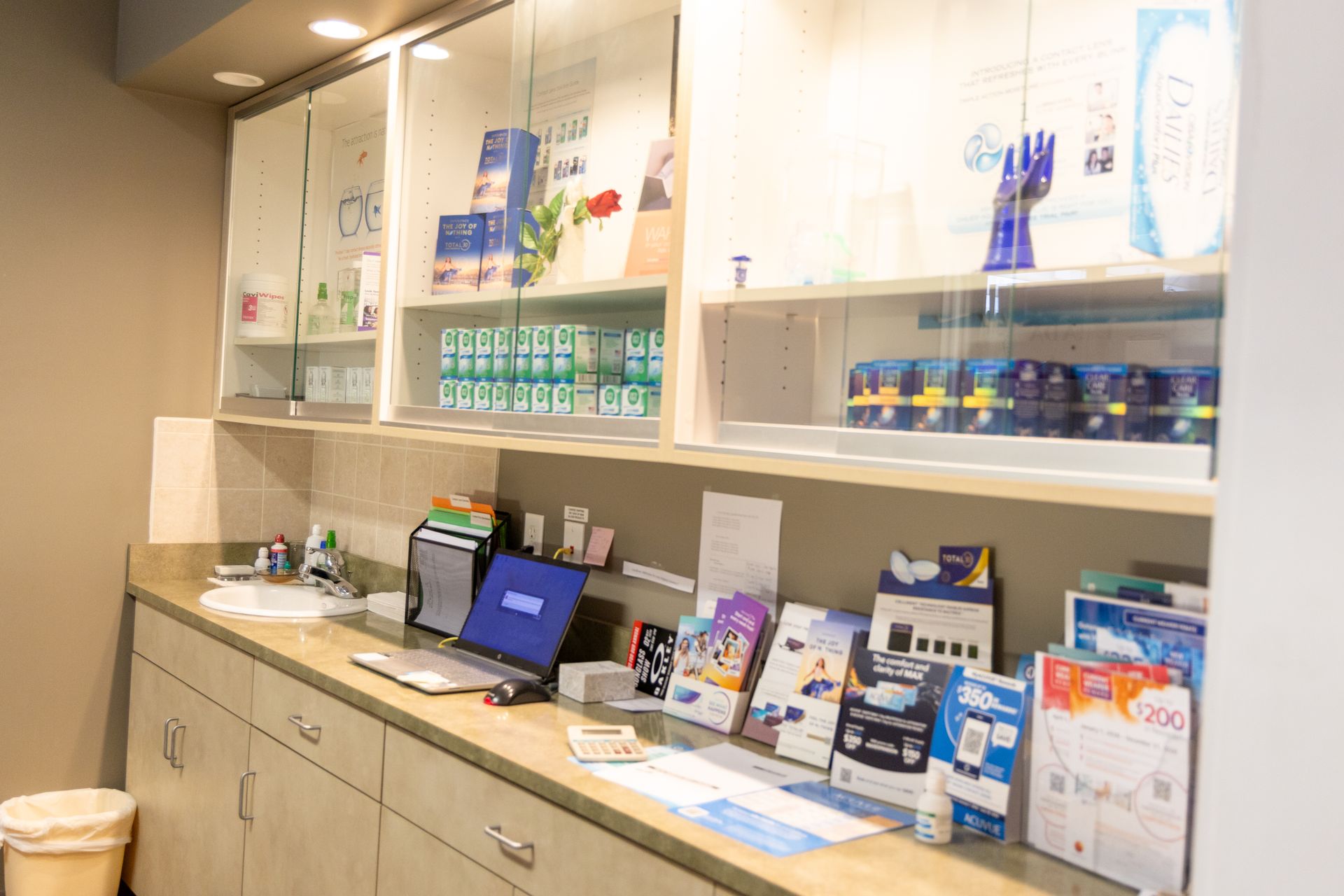 Modern retail display with shelves of products, brochures, and a touchscreen kiosk in a bright store interior