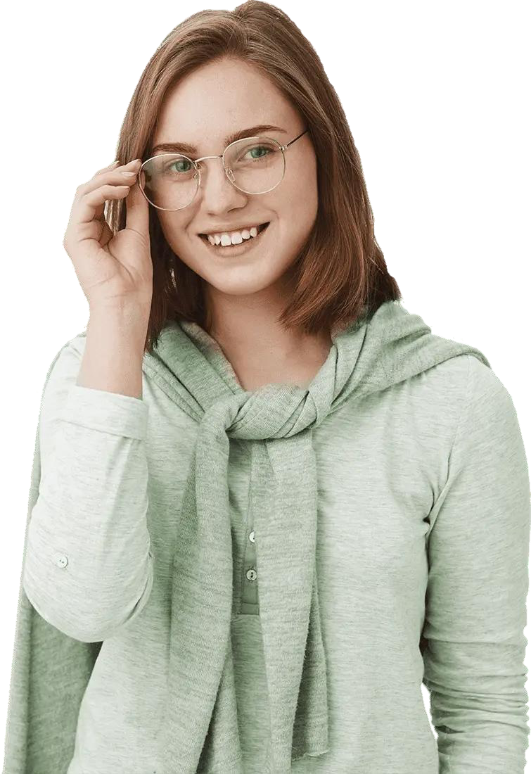 Smiling person in a light green sweater adjusting glasses on a white background