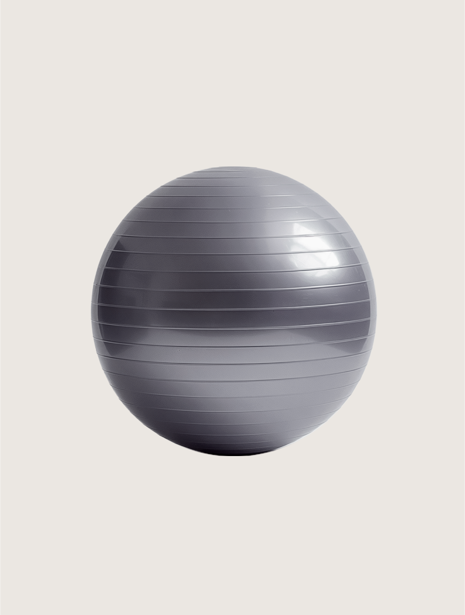 A gray exercise ball with horizontal ridges against a light background.