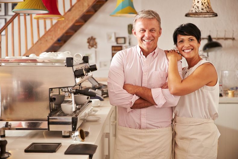 Happy Small Business Owner in Cafe