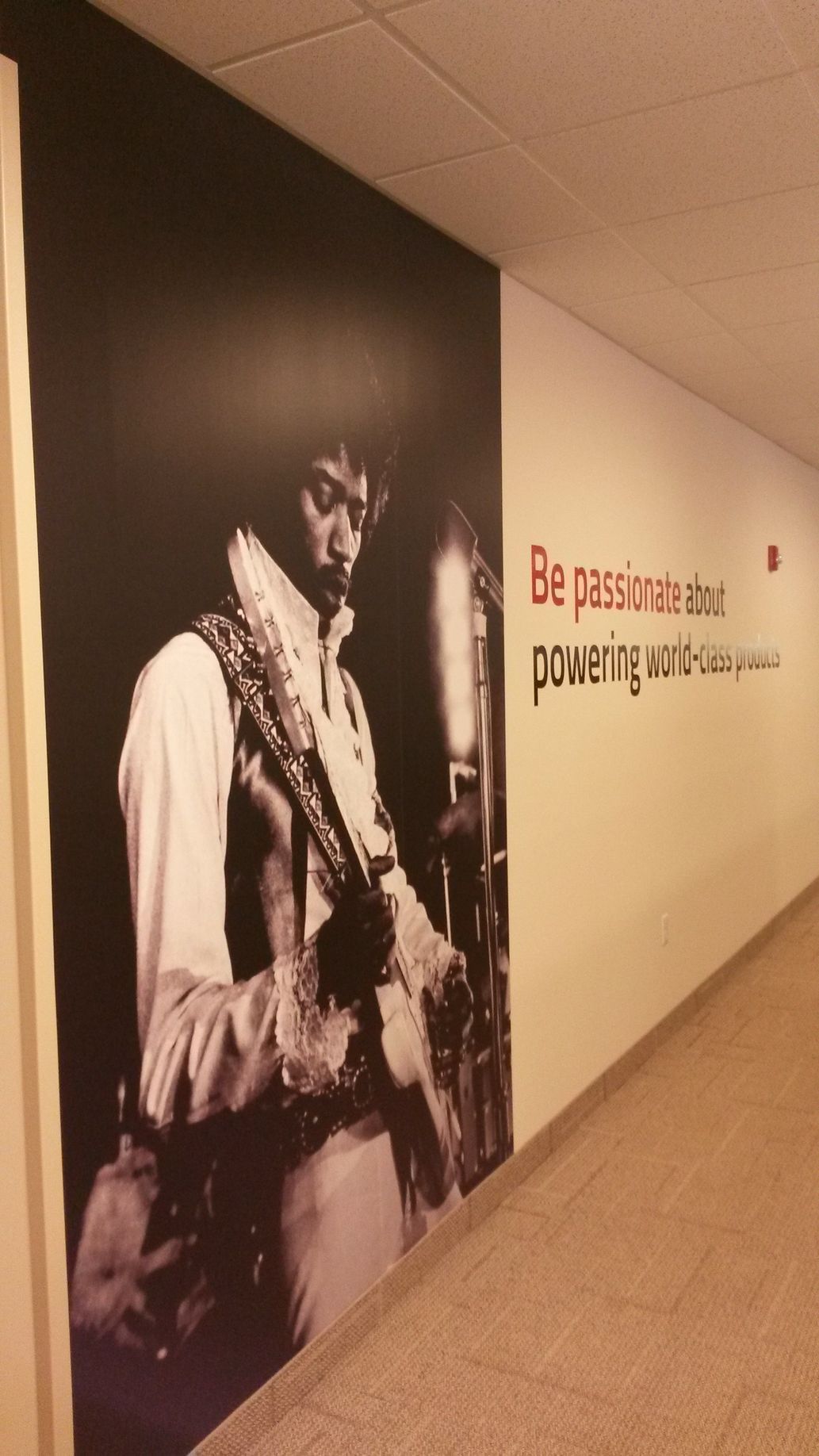 Wall mural of a musician in a recording studio. Text reads, 