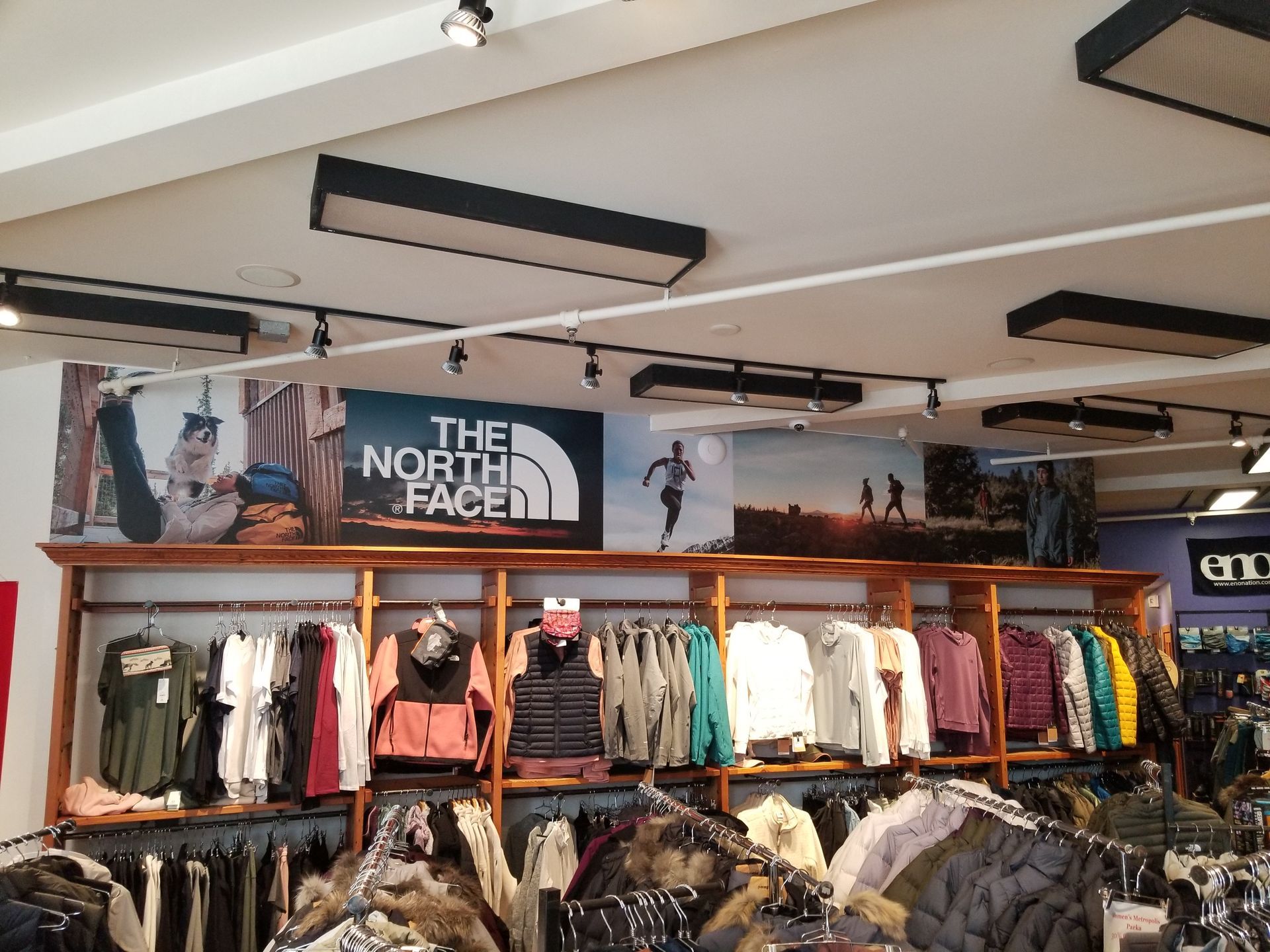 The North Face clothing display in a retail store with jackets and apparel on racks