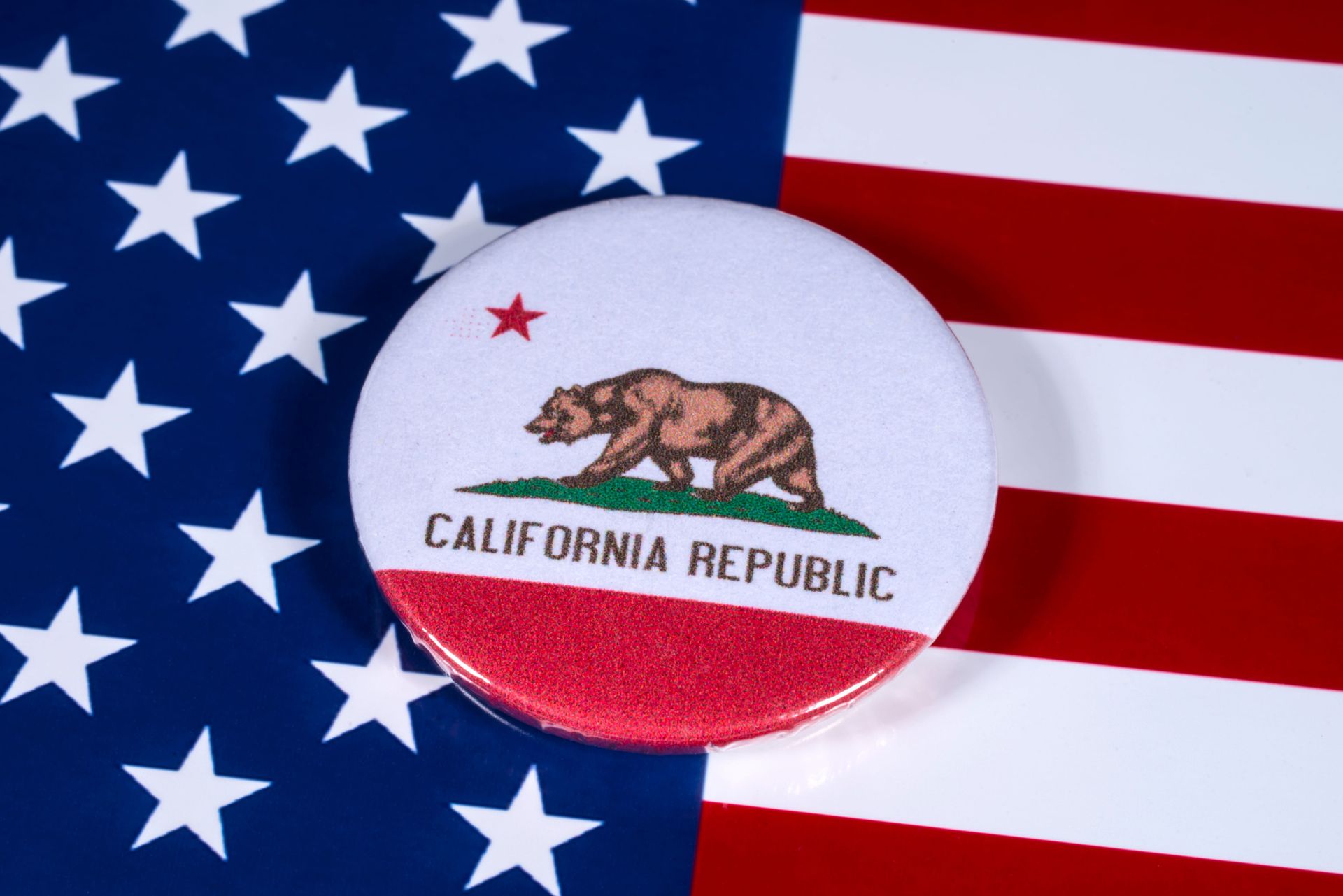 California flag button over a U.S. flag background