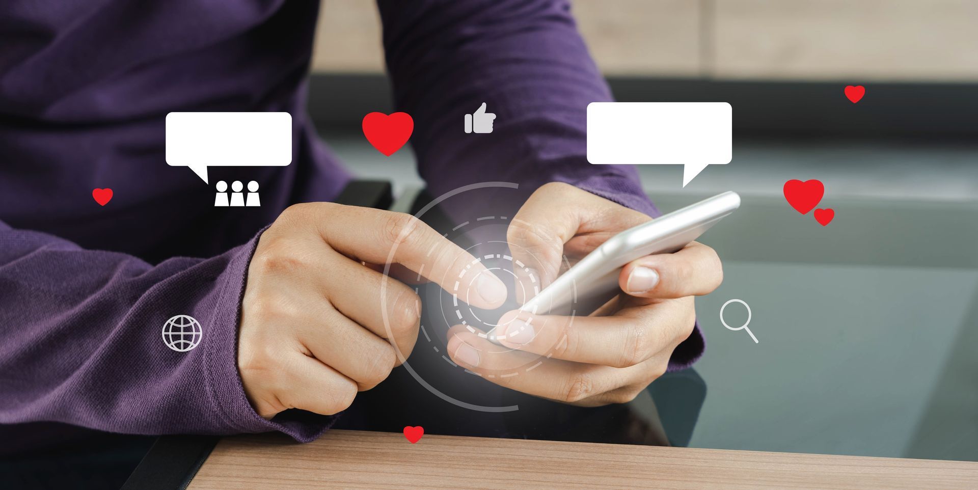 Person using a smartphone with floating heart and chat icons over the screen