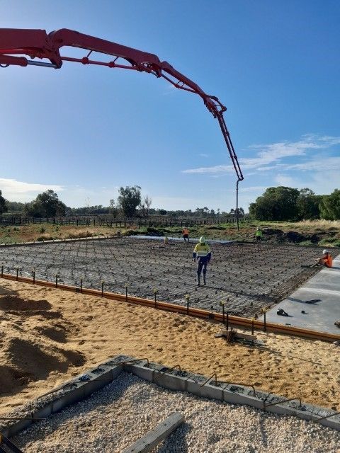 Construction workers troweling wet concrete | Bunbury, WA | Hutton Concrete