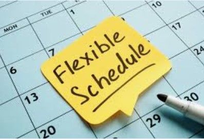Yellow sticky note on a calendar that says “Flexible Schedule” with a pen next to it.
