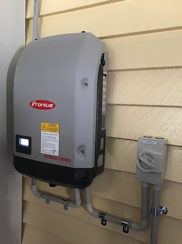 A Fronius Inverter Is Mounted on The Side of A House  — Central Solar Services in Garbutt, QLD