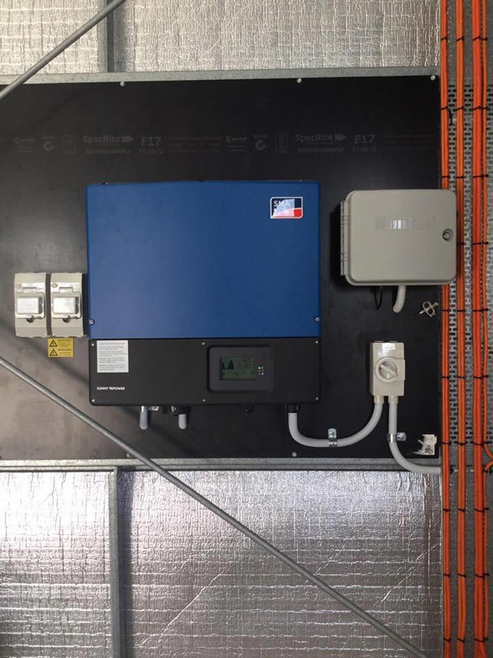 SMA solar inverter and switchboard components installed on a black backing board in Townsville