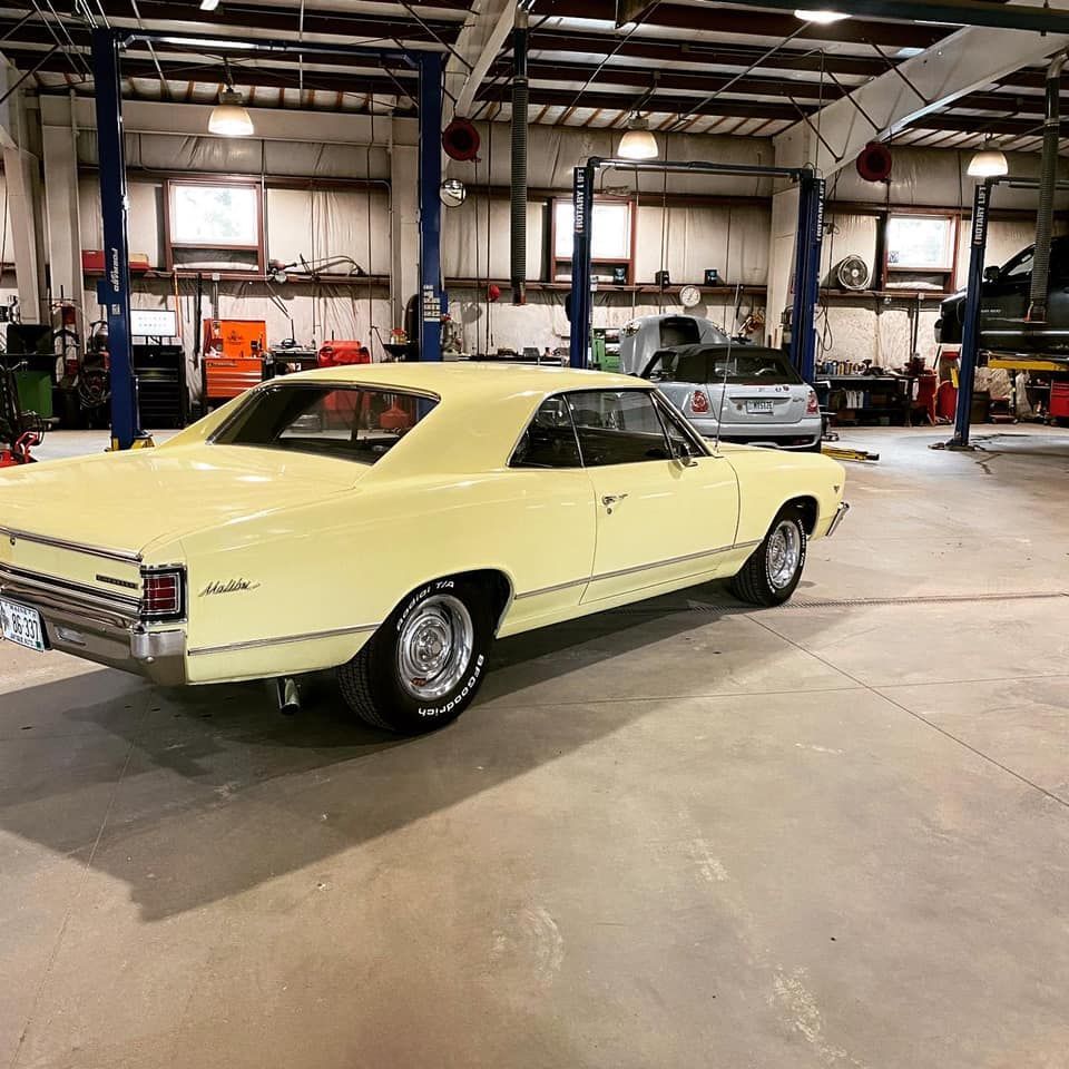 Classic Yellow Car Inside Auto Repair Shop | Neil's Motors Inc