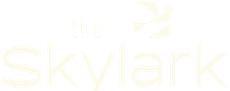 White logo text reading “the Skylark” on a white background